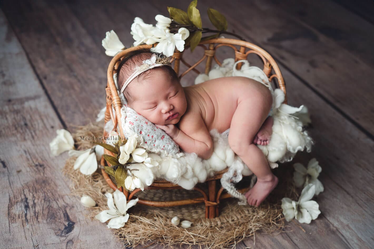 Newborn photography Singapore newborn baby laying on rustic rattan chair