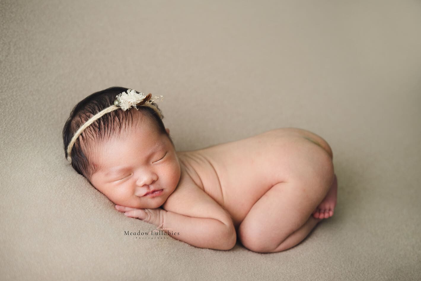 Newborn Photography baby smiling with bum up pose