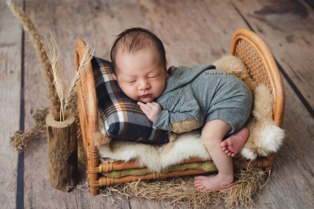 Newborn Photography Singapore Newborn baby photoshoot laying on rattan bed